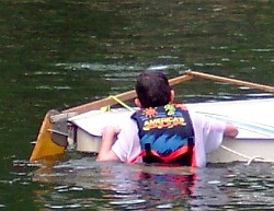 capsized sailing dinghy swim